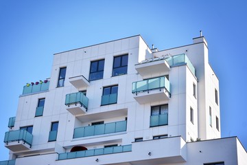 Contemporary residential building exterior in the daylight. Modern and new apartment building. 
