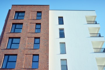 Contemporary residential building exterior in the daylight. Modern and new apartment building. 