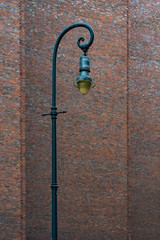 antique street lantern or lamp with a brick wall background
