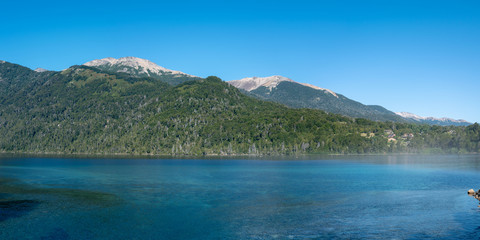 Stunning panorama of lake Correntoso in Nahuel Huapi National Park on a sunny day.