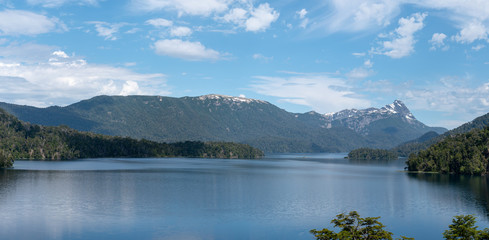 Stunning panorama of lake Espejo Grande in Nahuel Huapi National Park on a sunny day.
