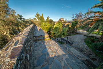 Medieval age scenery at the amazing and abandoned Granadilla town. The impressive medieval castle with it tower in between the surrounding defense wall inside an awe fantasy landscape with a moody sky