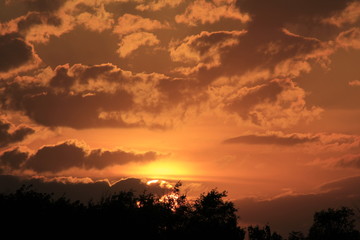 Colorful Kansas Sunset with clouds and the Sun.