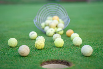 Naklejka premium golf equipment on green golf course, balls and sticks ready to play