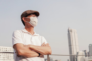 Middle aged Asian man wearing glasses and medical face mask,  Wuhan coronavirus covid-19 virus epidemic pandemic outbreak, self quarantine, air pollution and health concept