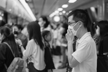 Black and white of middle aged Asian man wearing glasses and medical face mask,  Wuhan coronavirus covid-19 virus pandemic epidemic outbreak, quarantine, air pollution and health concept