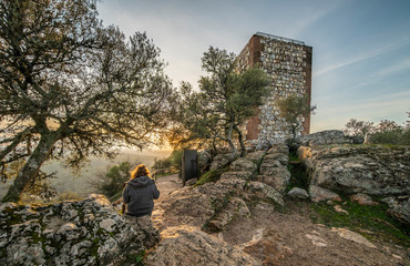 An outdoor woman tourist enjoy the amazing views during sunset of Extremadura countryfields, its...