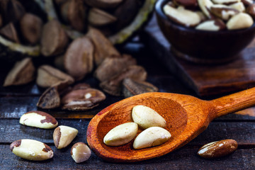 Photo of Brazil nuts, known as castanha-da-amazônia or chestnut-do-acre. Also grown in bolivia. Wooden background, with blur, space for text. known as 