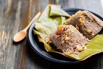 Northern Thai food (Khao Kan Chin), steamed pudding with rice, rice mixed with pork blood and steamed inside banana leaf
