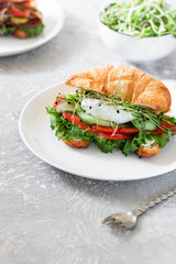 Croissant red fish and poached egg sandwich