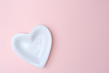 Heart plate on pink backgrop with copy space