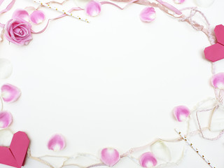 Valentines Day background. Rose, rose petals, heart, paper, straws and rope, beautiful Isolated on pastel pink backgrounds. Valentines day concept.View from above. There is a middle area on pink floor