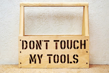 Wooden tool box, storage of screwdrivers, hammers, nails, pliers. A warning is burnt out on the board - do not touch my tools
