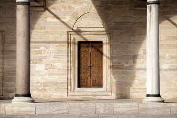 old wooden door with stone columns entrance to the mosque in istambul turkey
