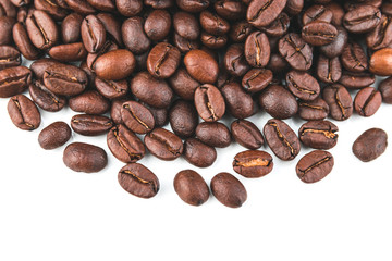 Dark coffee beans placed on a white scene.