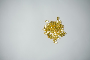 A pile yellow of Vitamin D-3 translucent gel capsules