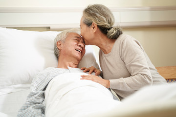 asian senior woman visiting husband in hospital