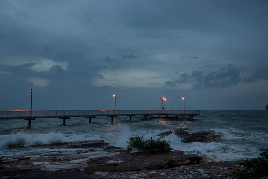 Jetty with large waves and high tide.