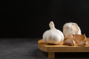 Garlic on the black table and black background.