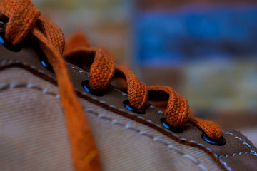 Sneakers close up. Shoelace of sport shoes macro texture. Shoes on wood board.