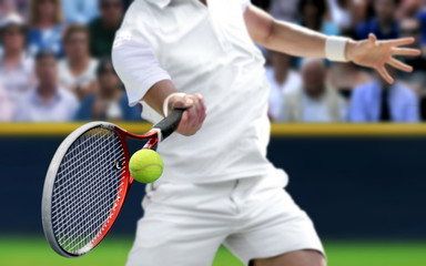 Male tennis player with forehand  racquet swing hitting ball