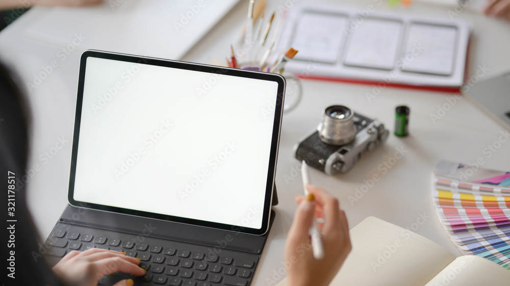 Canvas Prints close up view of female application developer working on blank screen tablet in co working space