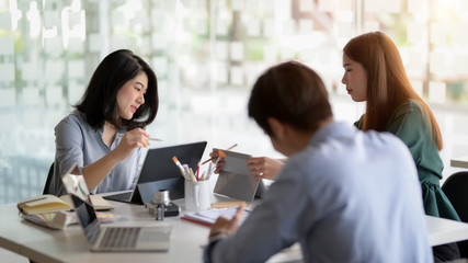 Close up view of team application developer consulting on UI project  in meeting room
