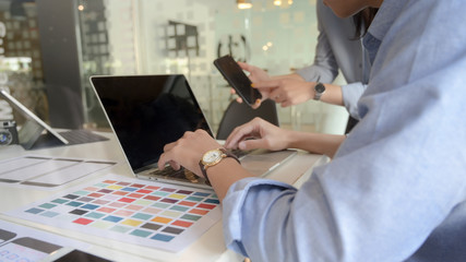 Close up view of application developer team focusing on their UI project in co working space