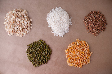 Circles of cereals oatmeal, mash, rice, peas and buckwheat on the table, top view