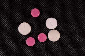Antibiotic pills on a black background. Healthcare and medicine concept