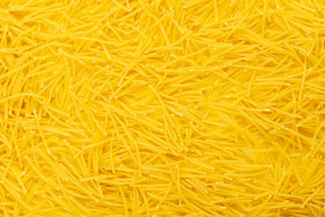 Small raw pasta background. Top view. Filini vermicelles close up flat lay.