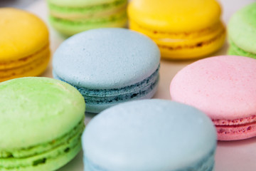 Different colorful macaroons background. Selective focus.
