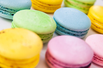 Different colorful macaroons background. Selective focus.