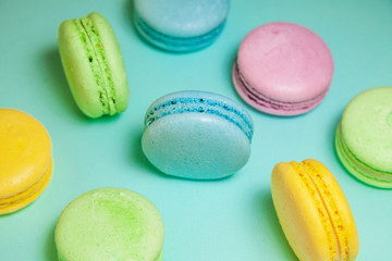 Different colorful macaroons on blue background