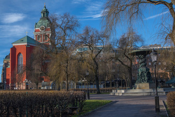 Fototapeta na wymiar Stockholm central city park Kungsträdgården with the church Jakob, the Opera house and statues