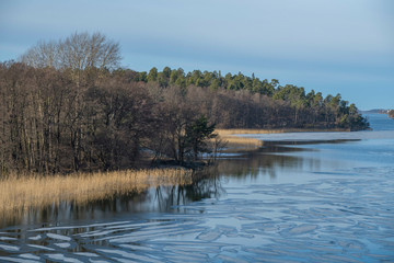 Winter landscape over a partly frozen lake M&auml;laren in the district of Bromma in Stockholm a cold sunny day.