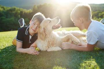 Children with a dog in nature.