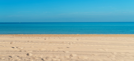 Tropical sea beach with sand, ocean and blue sky