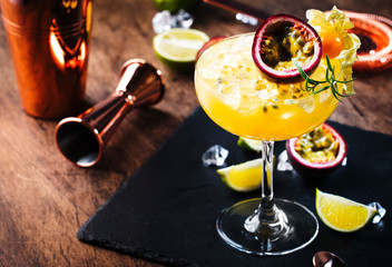 Pure passion, alcoholic cocktail with syrup, lime, orange juice, soda, ice and passion fruit
