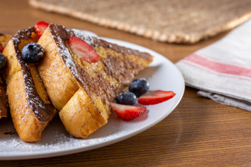 A plate of French toast in a restaurant or kitchen setting.