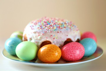 Easter holiday.Easter holiday. Multicolored eggs and Easter baking  on a light beige background.Spring festive religious background.