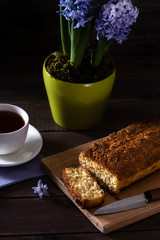 Pie with violet hyacinth on the wooden background