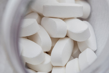 oval white tablets close-up, medicine and healthcare