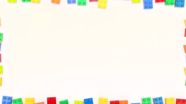 Toy bricks appear and disappear from white background like frame and border - Stop motion