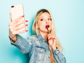 Young beautiful hipster bad girl in trendy jeans summer clothes and earring in her nose.Sexy...