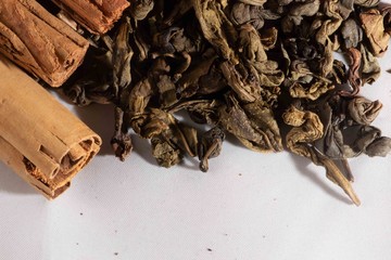 Cinnamon stick with ceylon green tea leaves - sri lankan green tea - gun powder