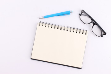 Top view blank notebook with pen on white background