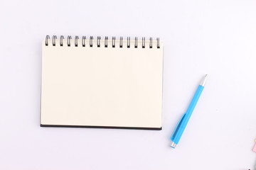 Top view blank notebook with pen on white background