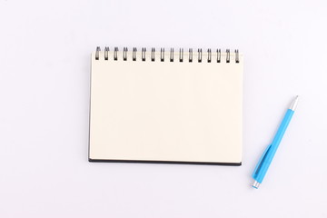 Top view blank notebook with pen on white background