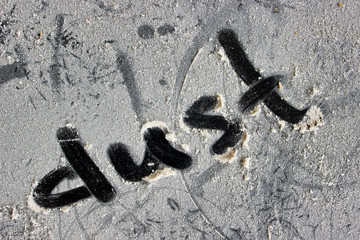A dusty surface with the word dust written on it.